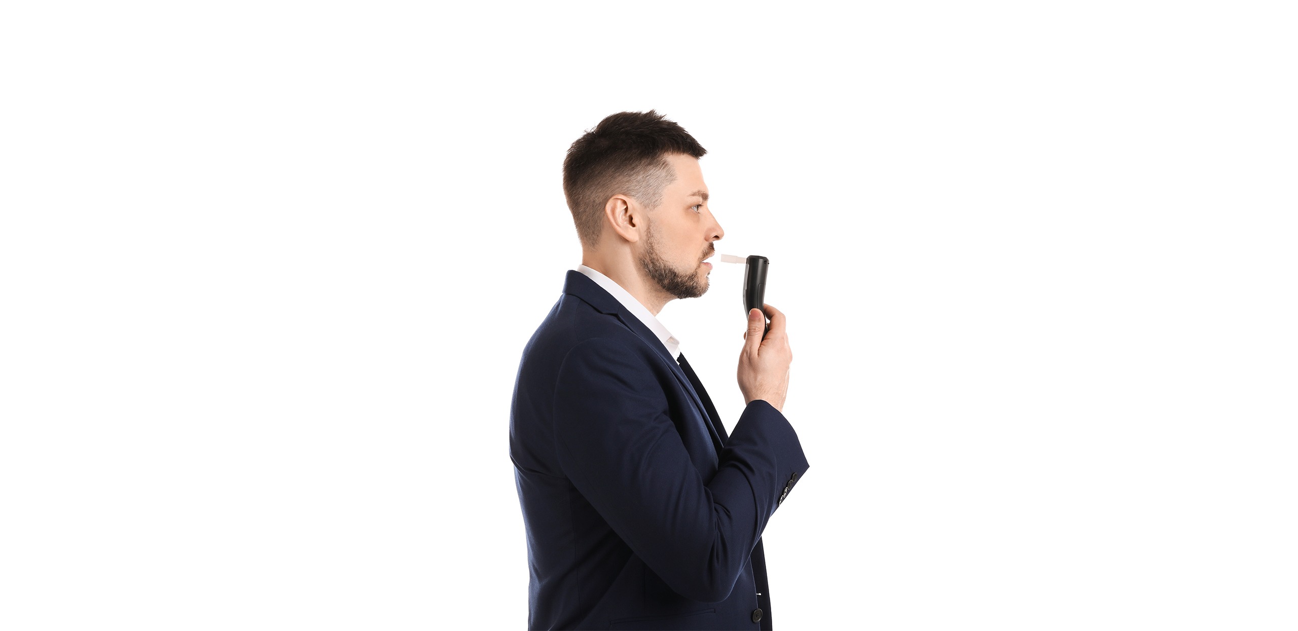 Man blowing into breathalyzer on white background